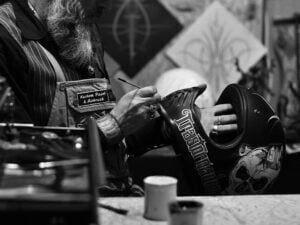 man painting helmet