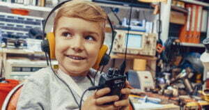 kid wearing headset and holding walkie talkie