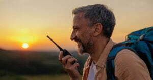 man holding walkie talkie and talking