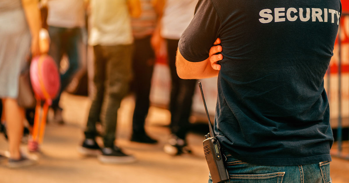 security guard at live festivale event standing in front of the crowd