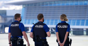 three policemen on patrol at airport