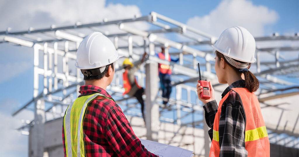 engineer wears white safety helmet stand hold blueprint and radio